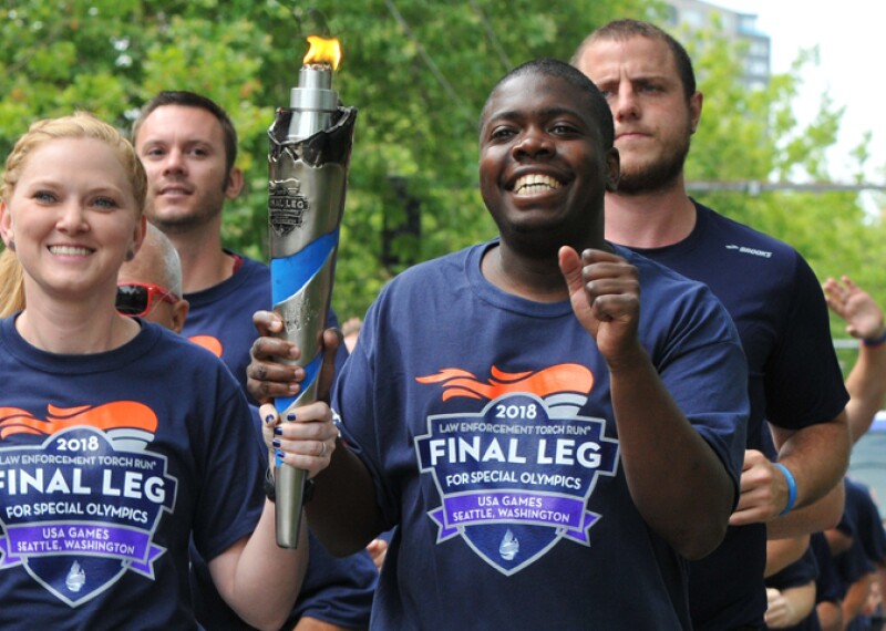 Group of runners running and holding the flame of hope. 