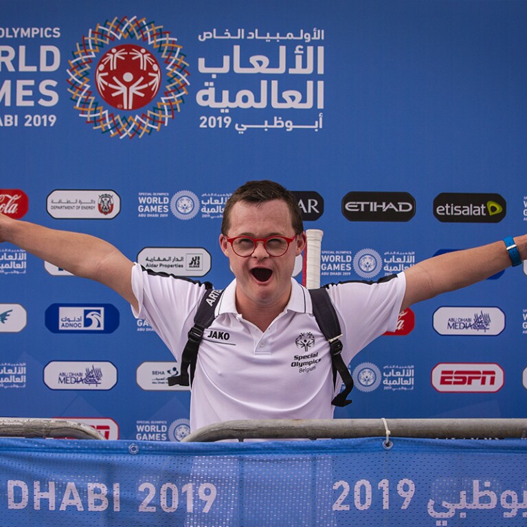 Young man cheering with his arms stretched out