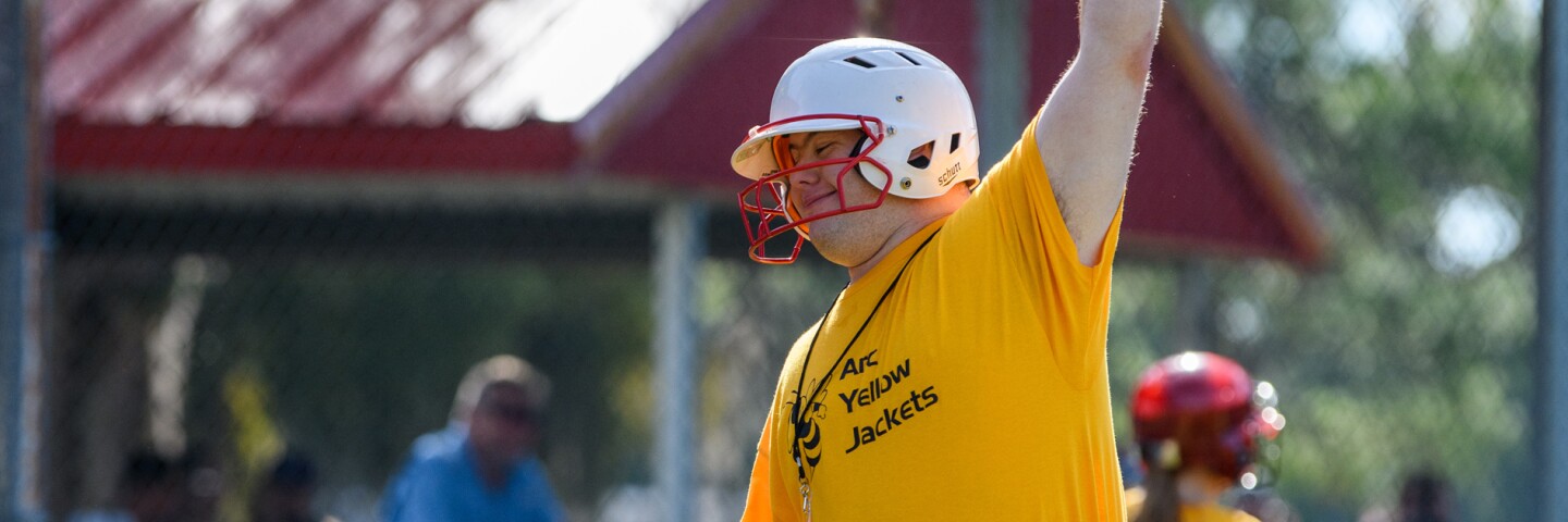 athlete on the field with his arm raised. 