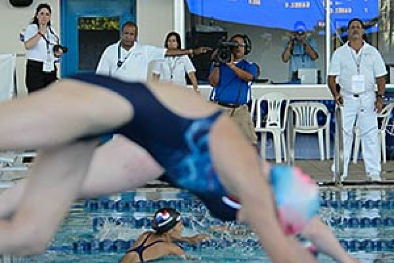 Officials in white shirts observe the start of a race at the Special Olympics World Aquatics Invitational in Puerto Rico in 2012.