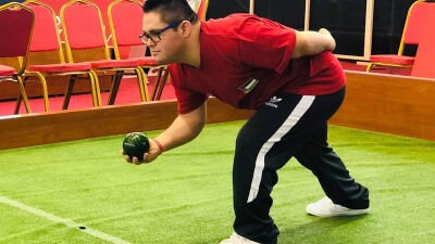 Young man playing bocce. 