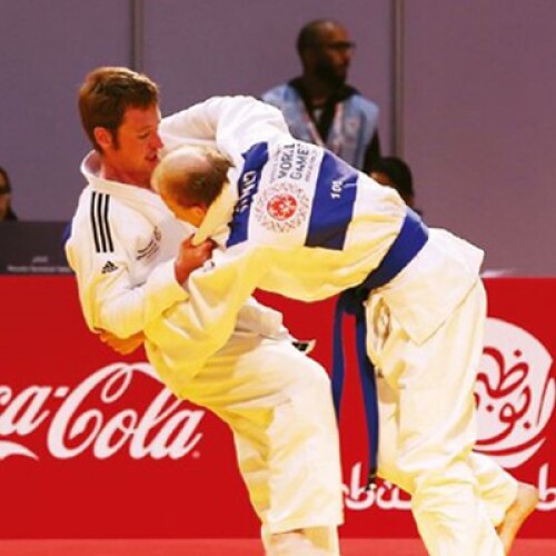 Two athletes competing in judo. 