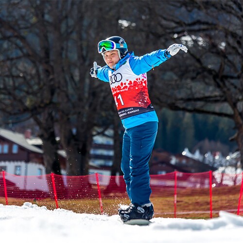 Snowboarder moving across the snow. 