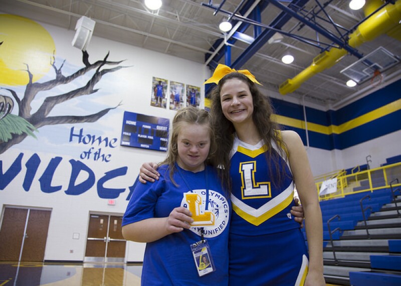 two cheerleaders standing side by side.