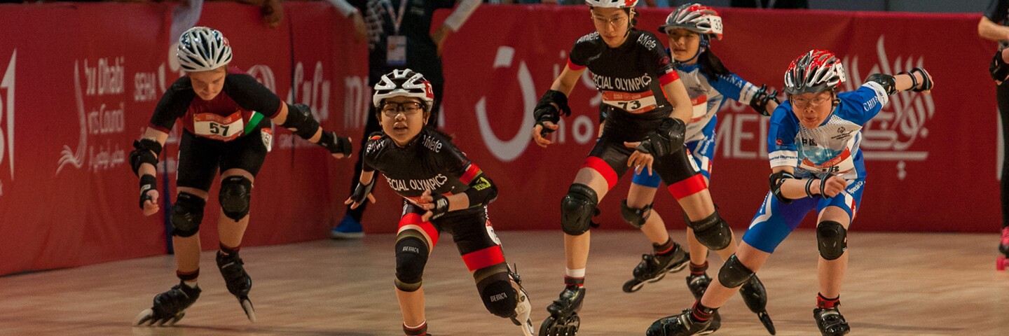 5 athletes racing in the roller skating rink. 